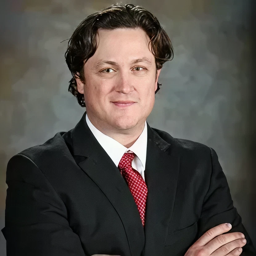 Man in suit smiling confidently